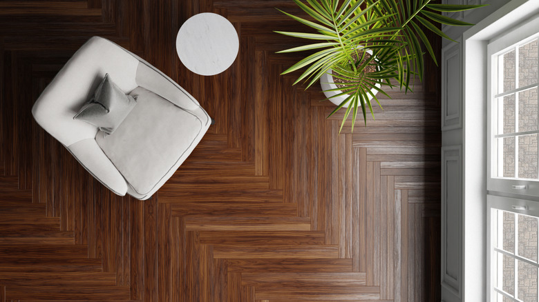 Top-down view of parquet floor and armchair