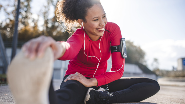 Person stretching listening to earbuds