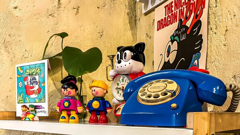 Vintage and whimsical figurines and decor on shelf in home