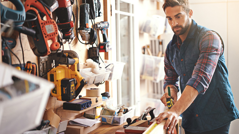Man works with tools in garage