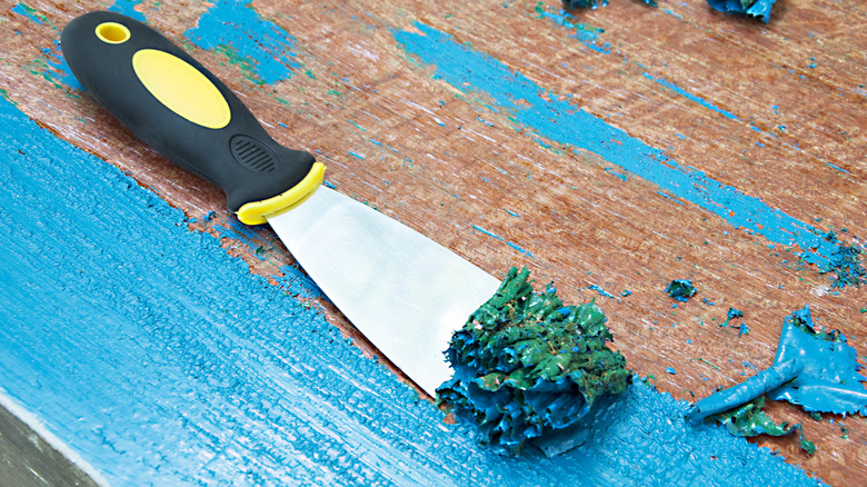 Scraping blue paint from wood furniture