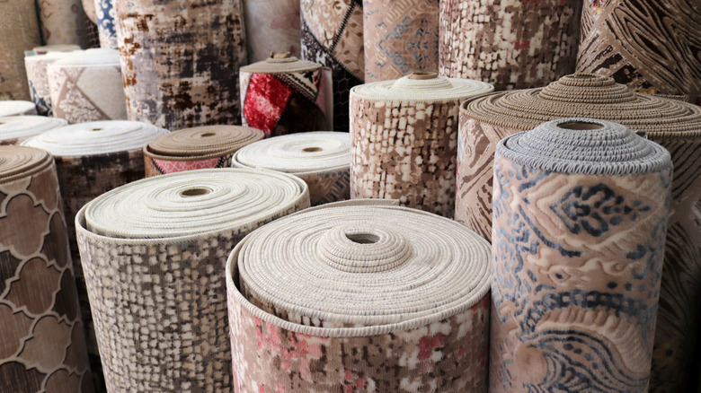 rolled up rugs in store