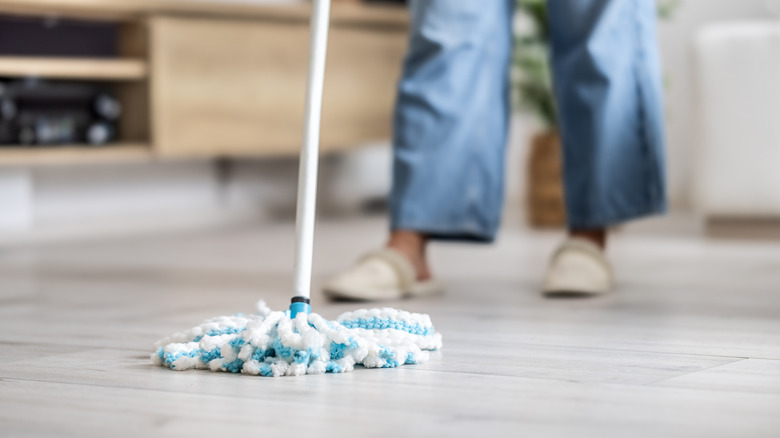 Close up of someone using microfiber mop on laminate floor