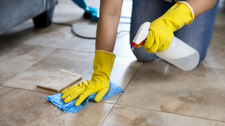 A person cleaning the floor with vinegar