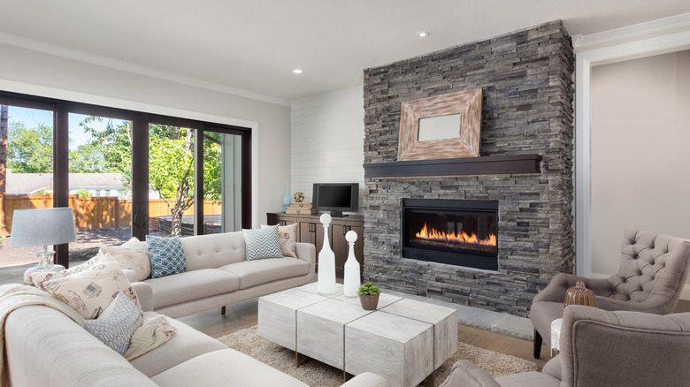 A contemporary living room with a large gas fireplace