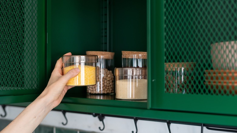 Jars being placed in wire mesh cabinet