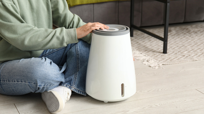 A person turning on a humidifier