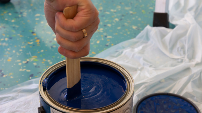 stirring paint with stir stick