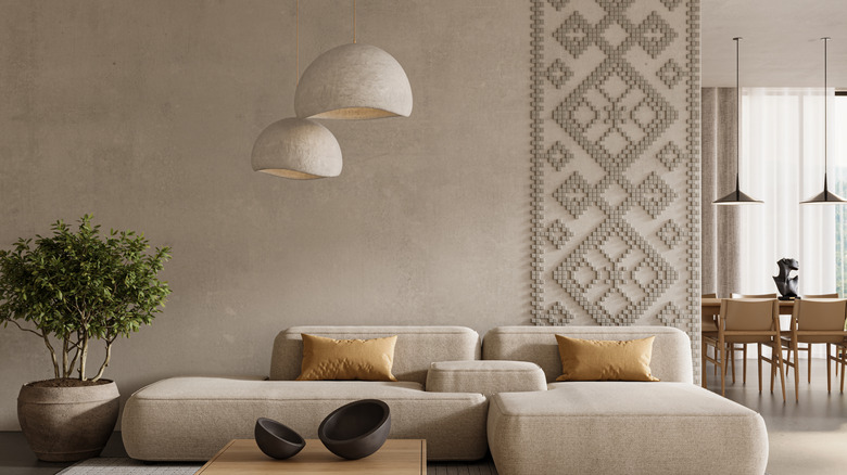 Modern and minimalist decor with plaster pendant lighting, textured sofa, and limewash walls