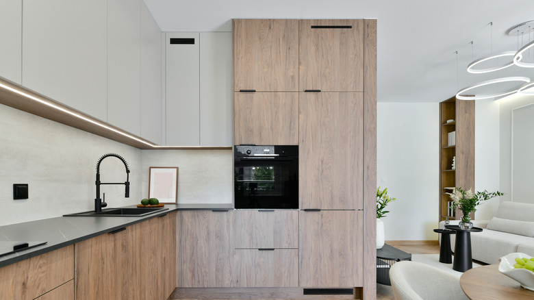 Morden open concept kitchen with oak and beige cabinets