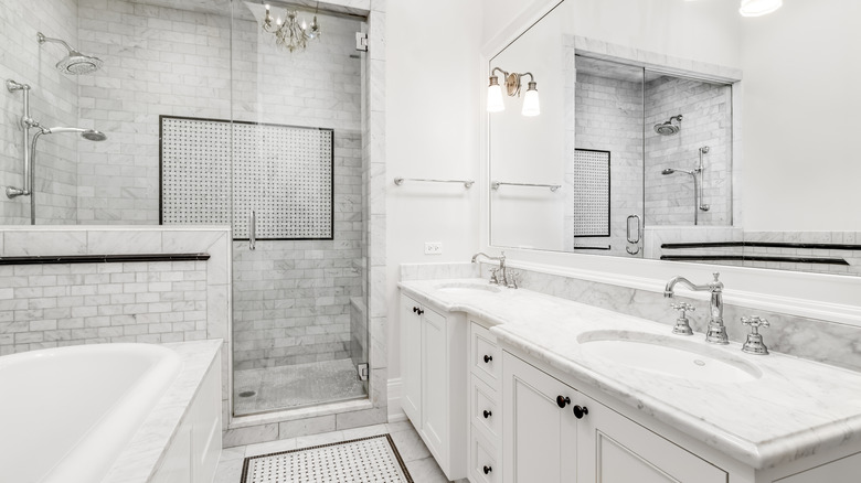 A luxurious white, gray, and black bathroom