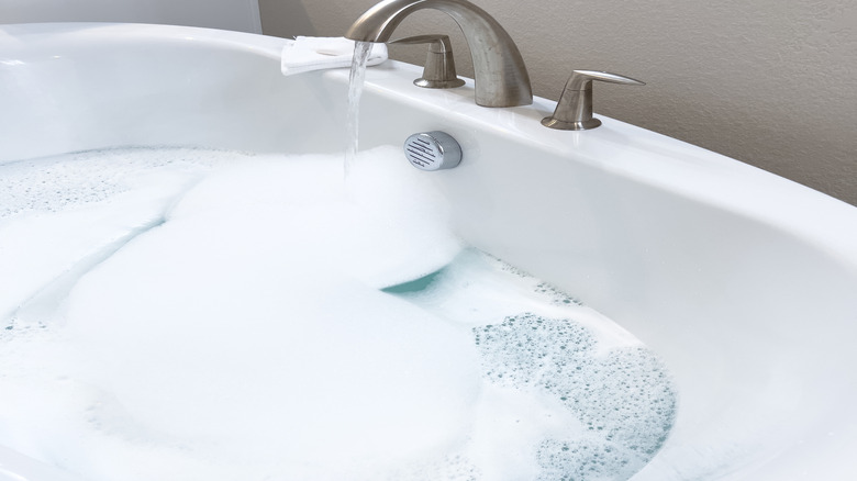 White bathtub with brushed nickel faucet