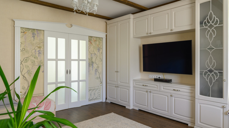 classic living room with white cabinets and hardwood floors