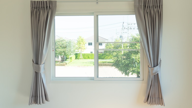Short, half-length gray curtains on window