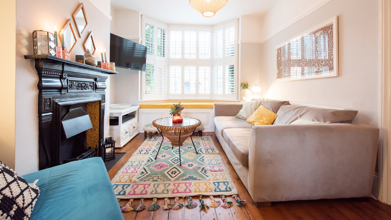living room with window bench, bay window, and fireplace