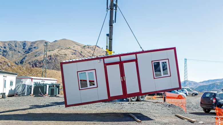 A prefab home being lifted with a crane