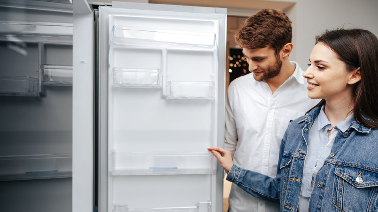 A couple shops for a new refrigerator.
