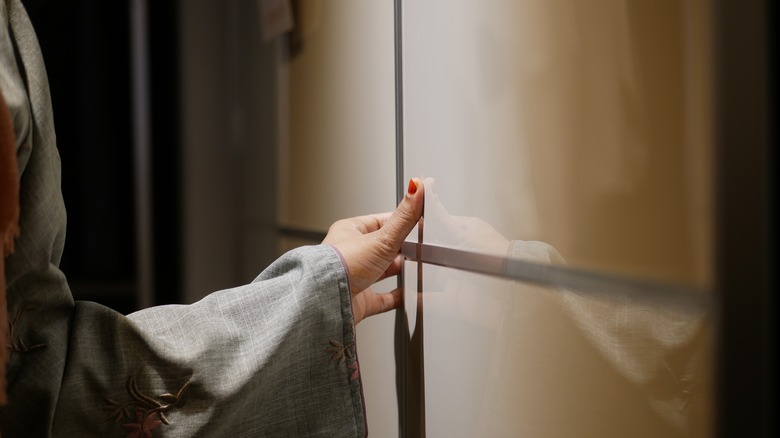 hand opening kitchen cabinet door