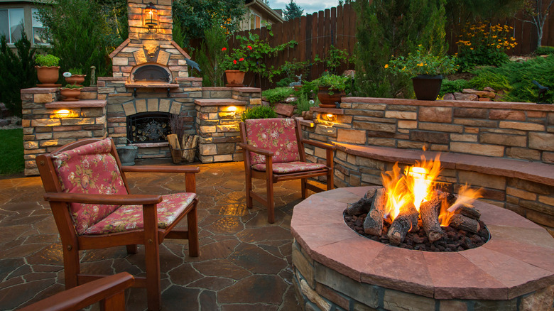 A patio with multiple natural elements, a fire pit and colors of nature