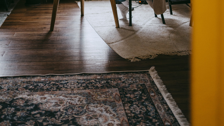 A woman working at a desk in a study-slash-parlor room.