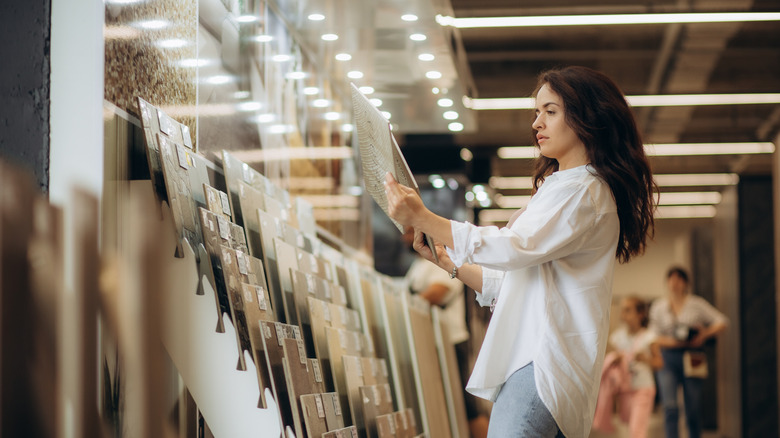 Woman in store choosing tile colors