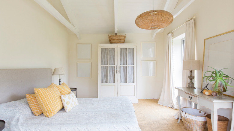 Bed and freestanding closet in bedroom of rustic house.