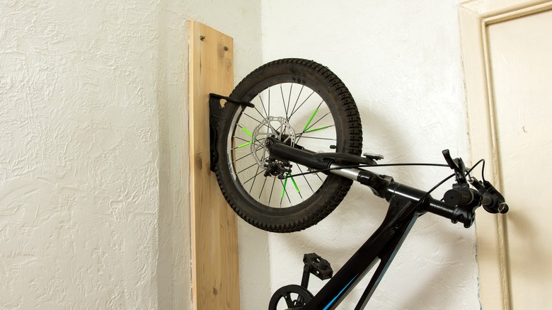 A mountain bike hooked onto a handmade storage hook
