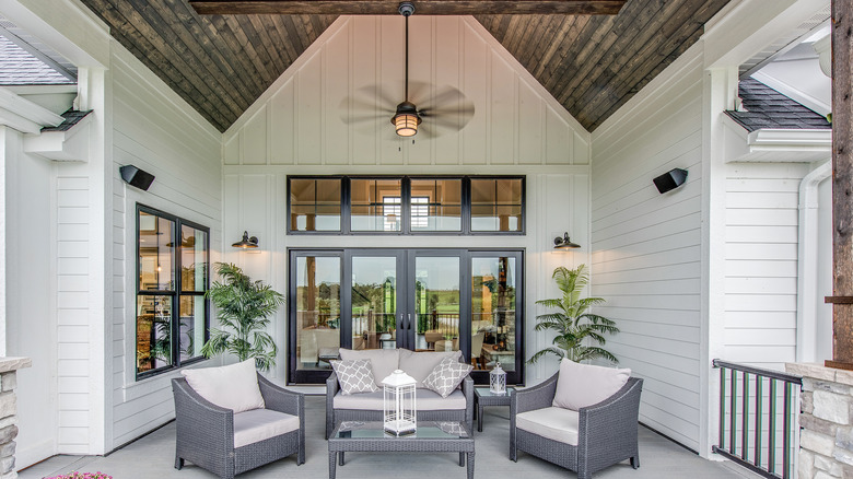 patio with outdoor ceiling fan with gray and white furniture