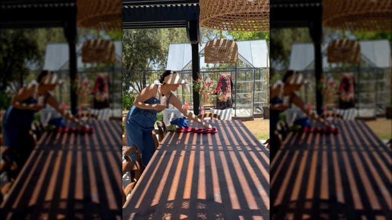 Woman cleaning a teak patio table