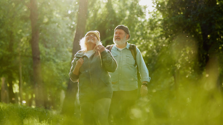 Older man and woman walking outdoors.