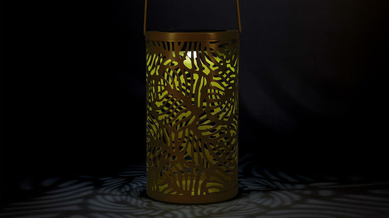 metal lantern casting floral shadows