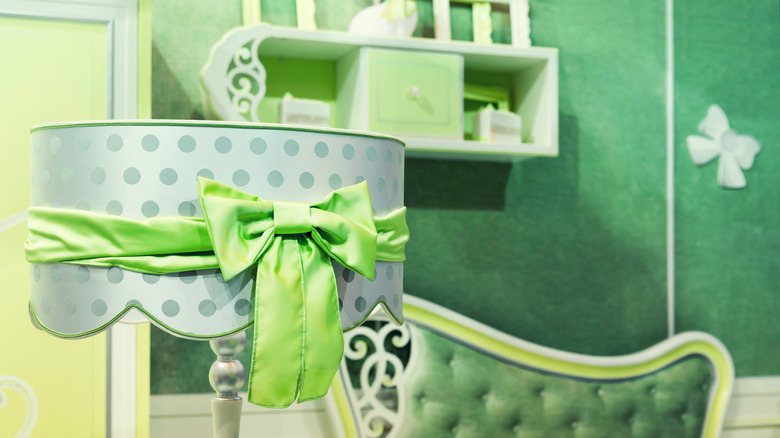 chartreuse bow wrapped around a lampshade in a green bedroom