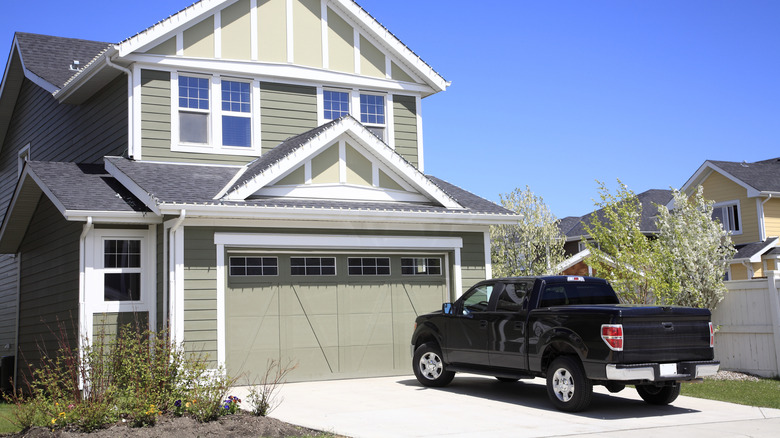 a two story home with a truck in the driveway
