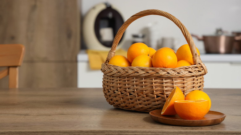 Wicker basket filled with oranges on kitchen counter