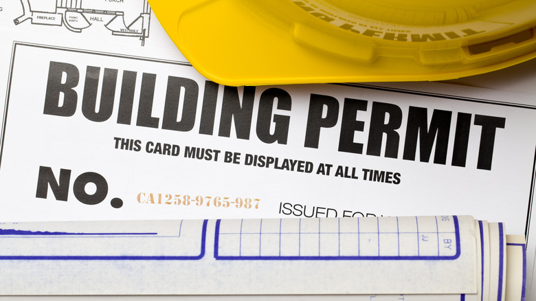 Building permit with a yellow hardhat on top