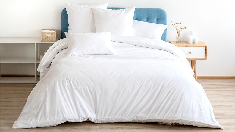 Oversized white comforter on bed