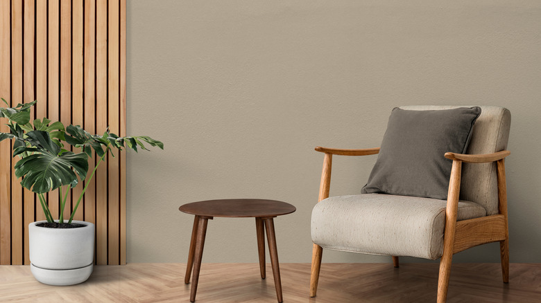 greige wall color with mid-century modern chair and side table