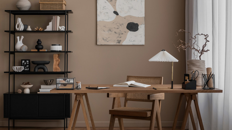 brown walls in office area with dark and natural wood furniture