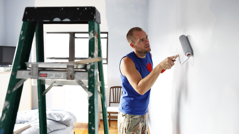 Man painting wall 