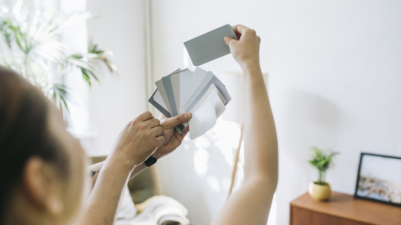 Woman views paint swatches