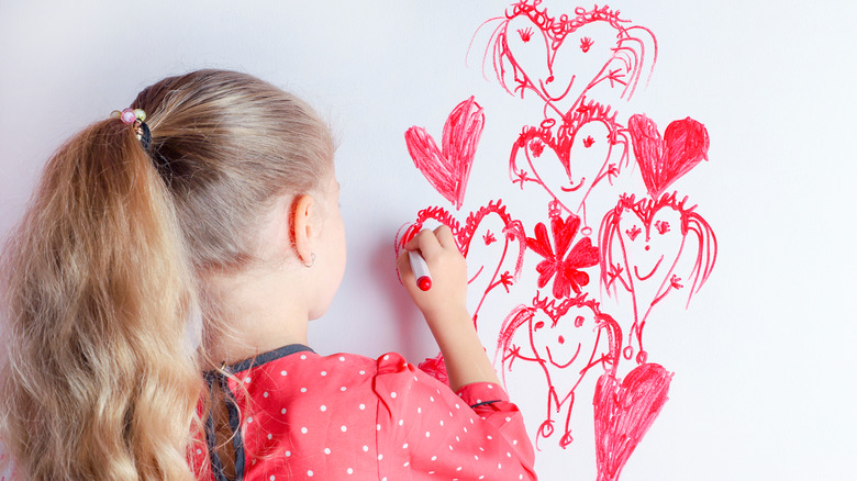 girl drawing on white board