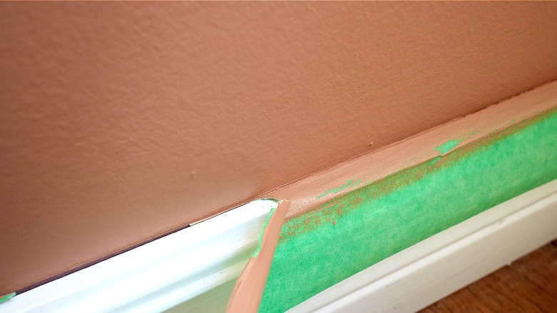 Person removing painter's tape