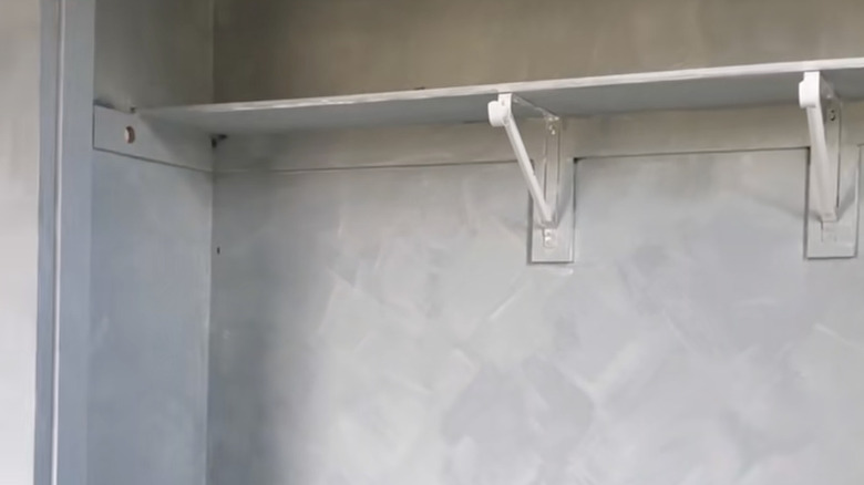 A closet interior painted using gray limewash paint.