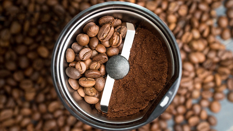 Grinder with whole and ground coffee
