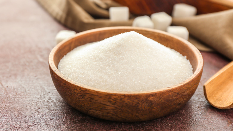 Wooden bowl of white sugar