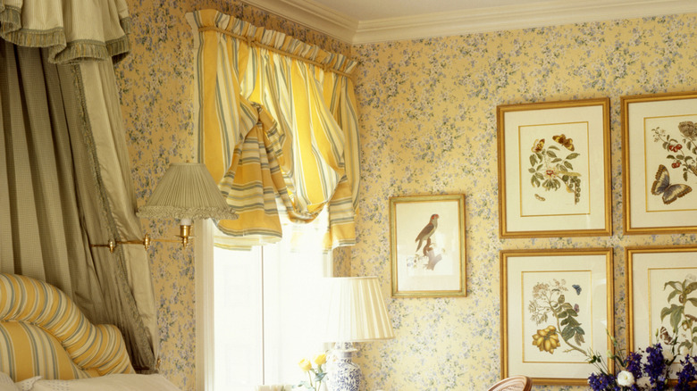 Vintage floral yellow wallpaper with striped curtains.