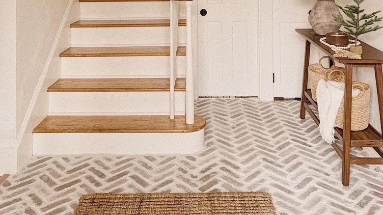 White bathroom with herringbone brick paver flooring