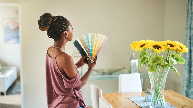 person paints green swatches