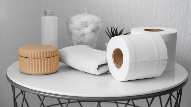 toilet paper and other bathroom items on table