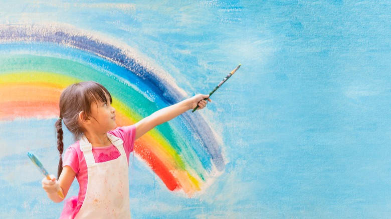 Girl painting a rainbow